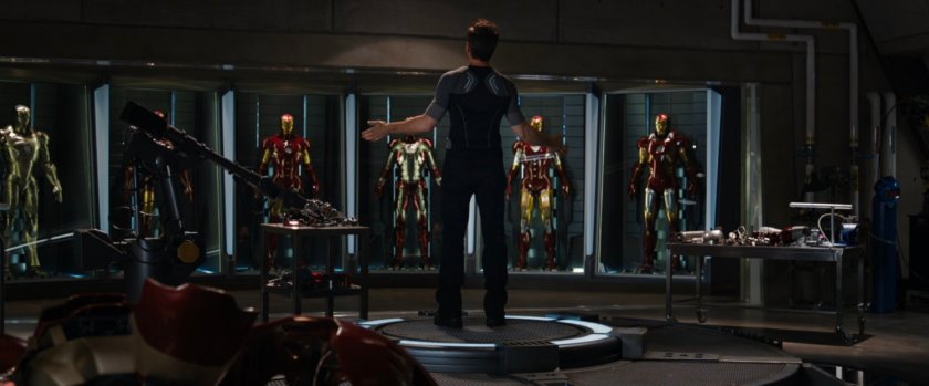 Tony and a wall of Iron Man armor.