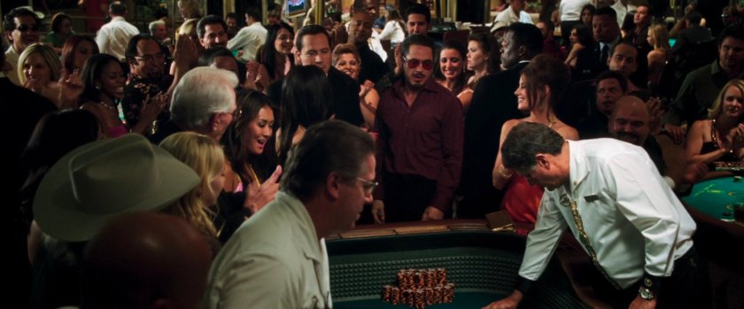 Tony Stark and a crowd at a craps table.