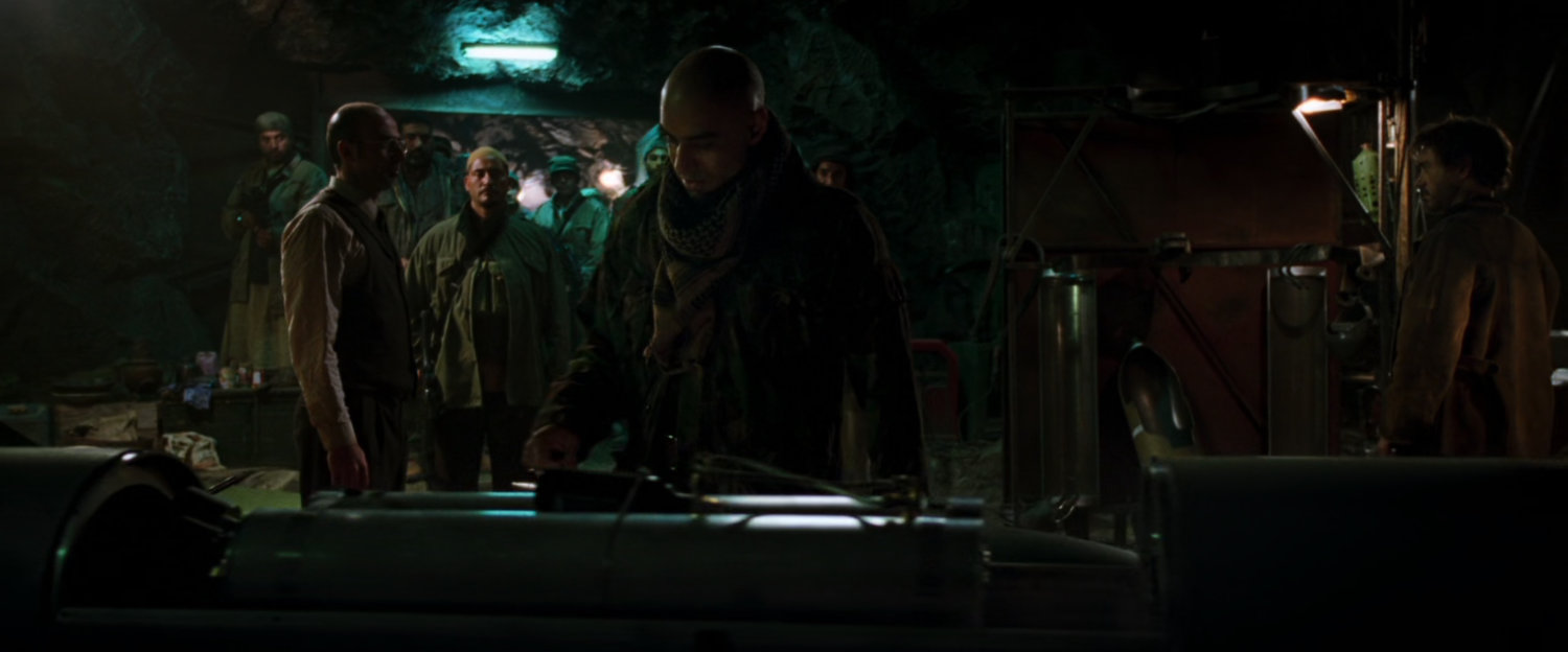 Raza inspects a weapon inside a cave.