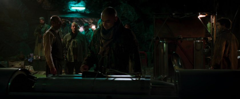 Raza inspects a weapon inside a cave.