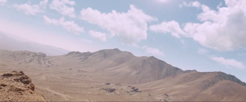 Desert hills with white clouds in the sky.