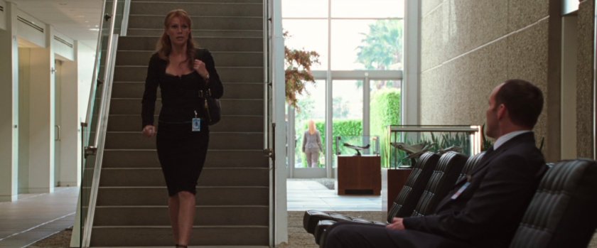 Pepper Potss walking down stairs towards Agent Coulson.