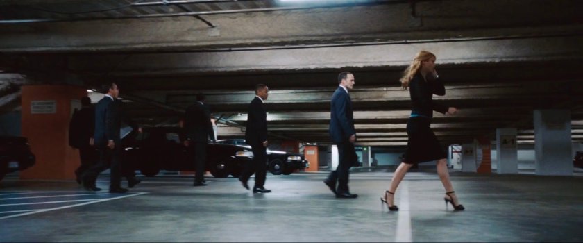 Agent Coulson and Pepper Potts walk through an underground SHIELD garage.