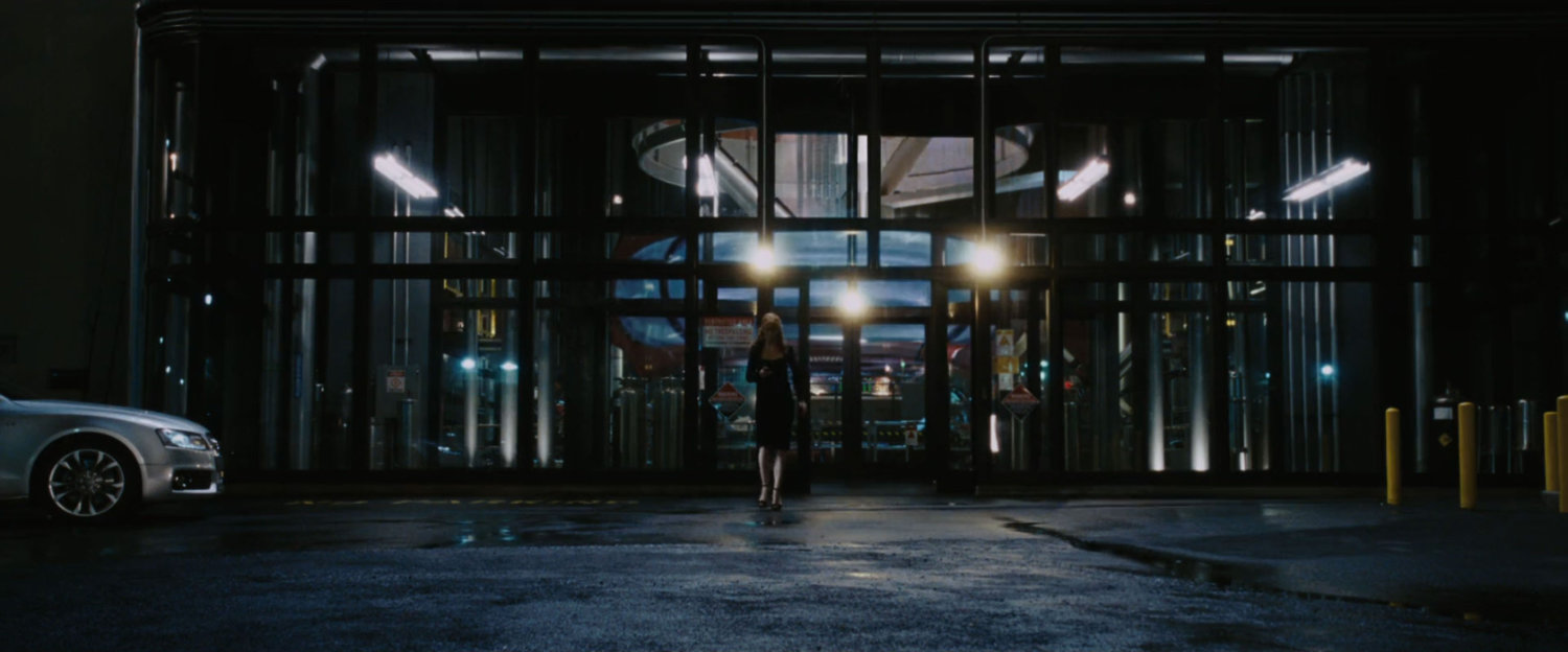 Pepper Potts looks through into the Arc Reactor building at night.