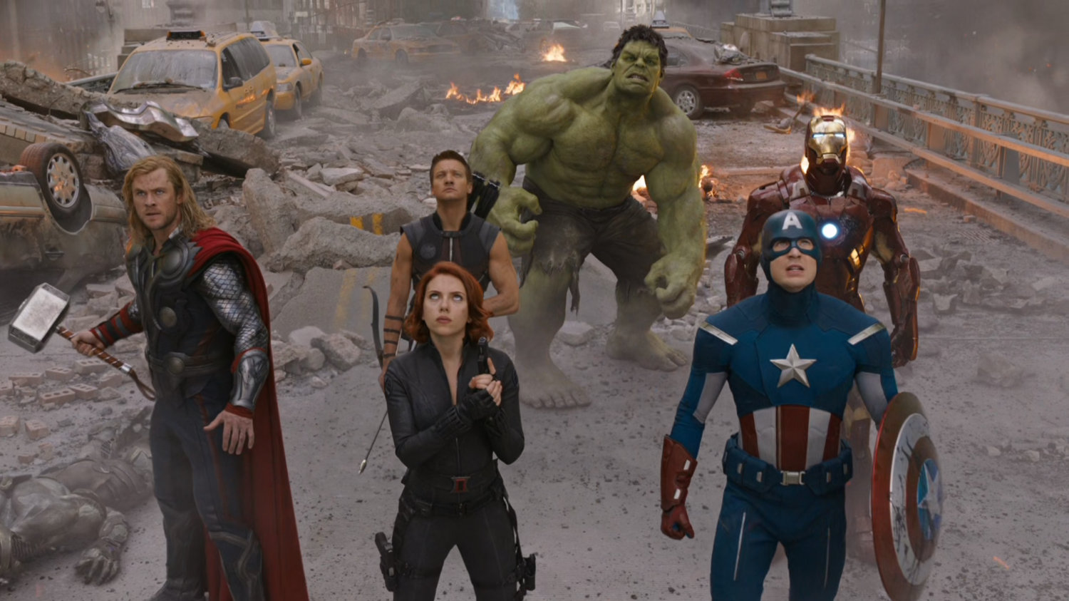 The Avengers stand on a demolished bridge in New York City.