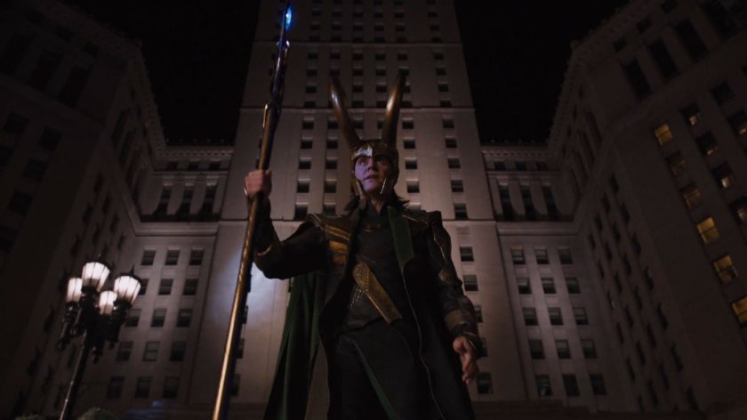 Loki stands out a tall building at night.