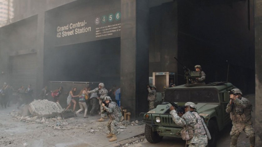 National guardsmen protect civilians in a debris filled sidewalk outside Grand Central station.