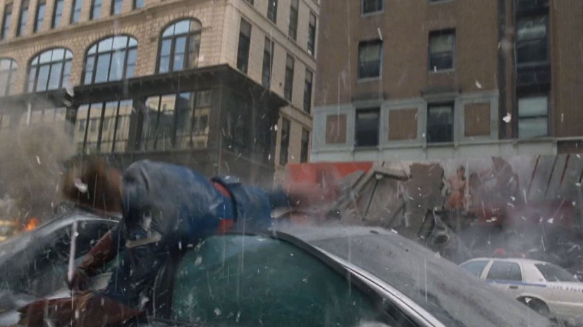 Captain America crashes onto a damaged car.