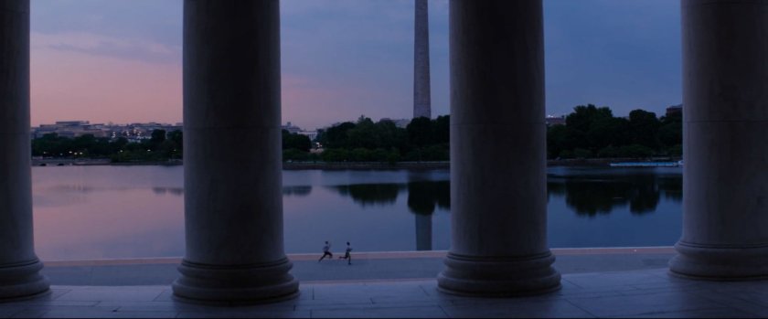Two figures jog past the Jefferson Memorial.