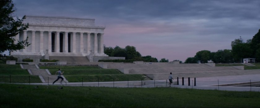 Two figures jog past the Jefferson Memorial.