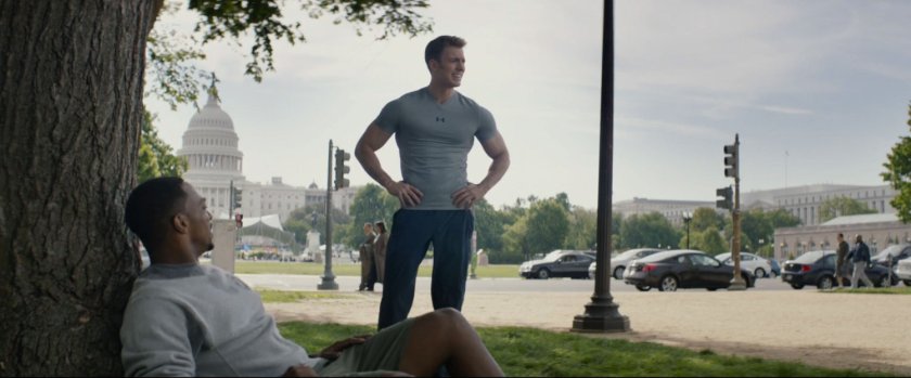 Sam Wilson and Steve Rogers rest under a tree with the US Capitol in the background.