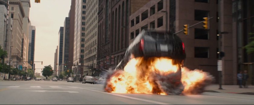 Black SUV begins to flip as explosion occurs underneath it.