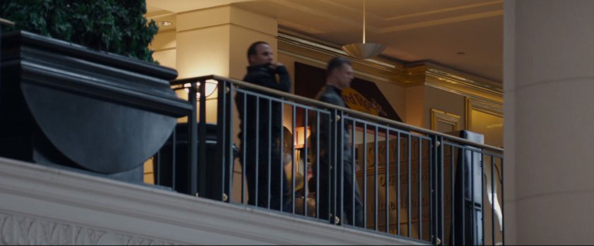 Two agents on a balcony in a shopping mall.