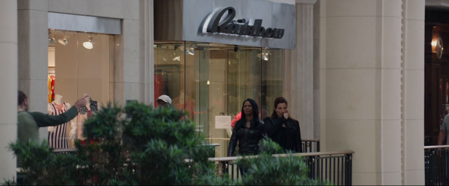 Two agents on a balcony in a shopping mall.