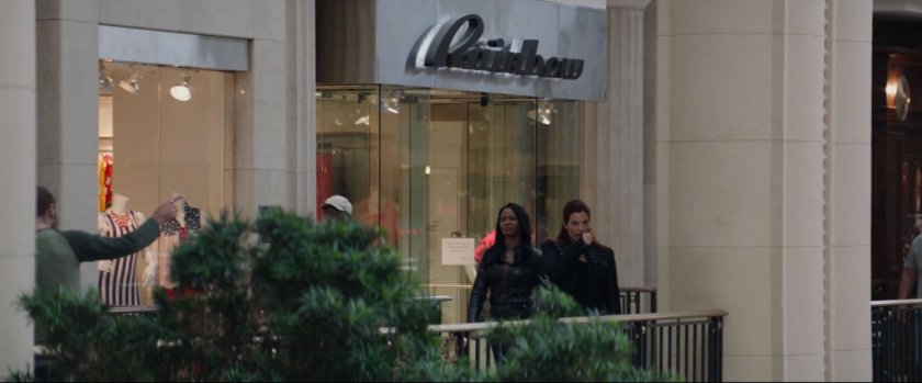 Two agents on a balcony in a shopping mall.