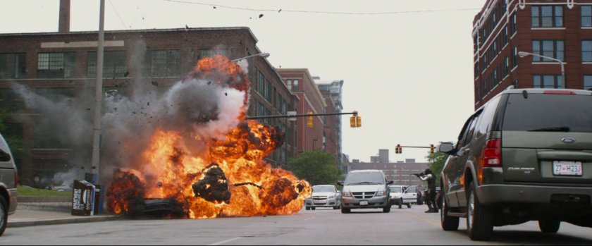 A car explodes on a city street by the Winter Soldier.
