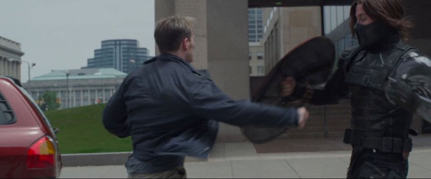 Steve Rogers fight the Winter Soldier in a street.