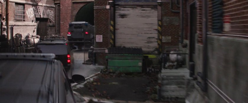 STRIKE vehicles entering a dilapidated warehouse.