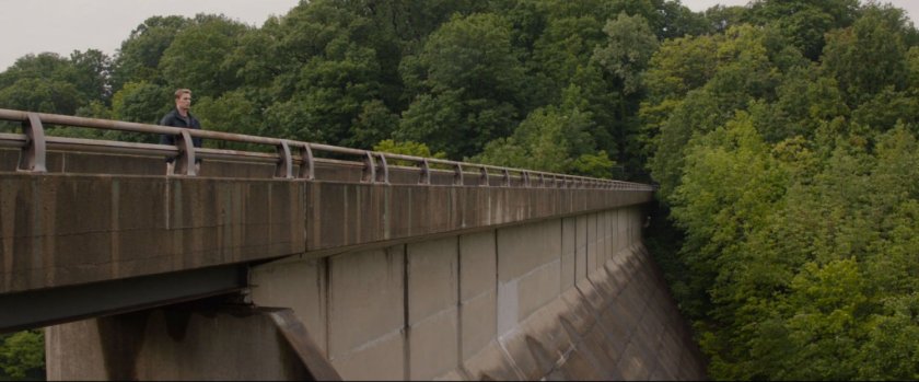 Steve Rogers standing on top of a dam.