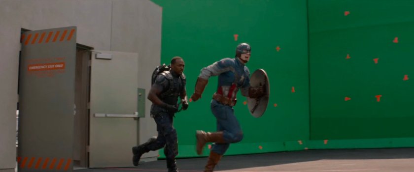 Behind the scenes image of Anthony Mackie and Chris Evans in front of green screen.