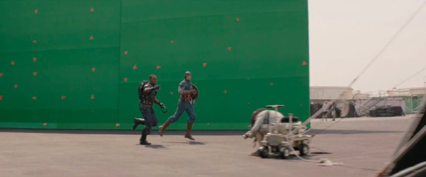 Behind the scenes image of Anthony Mackie and Chris Evans in front of green screen.