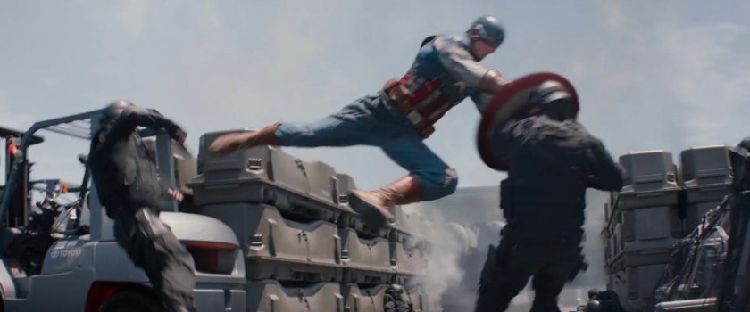 Captain America smashes a soldier with his shield.