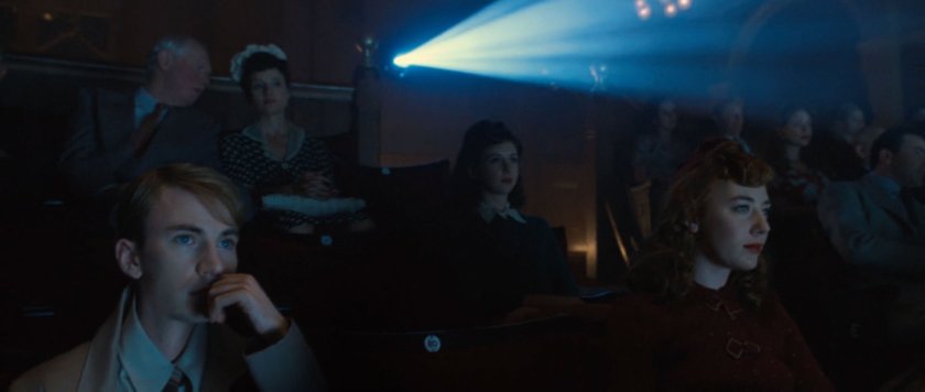 Steve Rogers in movie theater watching a newsreel.