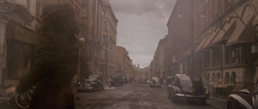 Peggy Carter stands in the middle of a 1942 New York street.