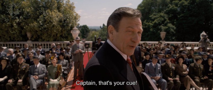 Senator Brand introduces Captain America to the assembled crowd.