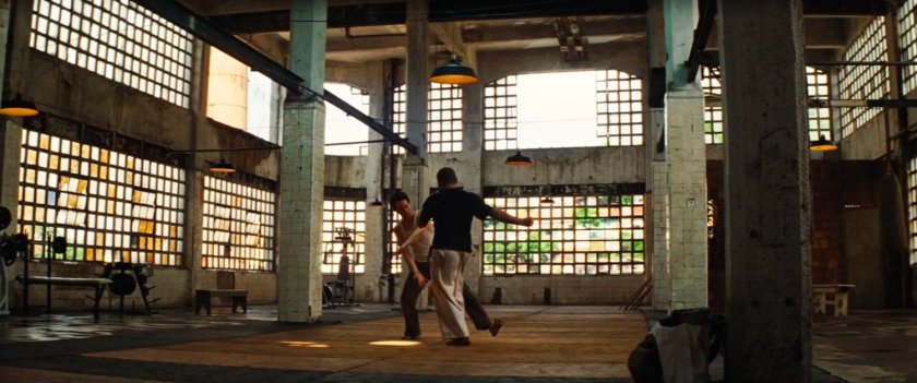 Bruce Banner and a trainer spar inside a training facility.