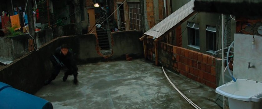 Emil Blonsky runs across a favela rooftop.