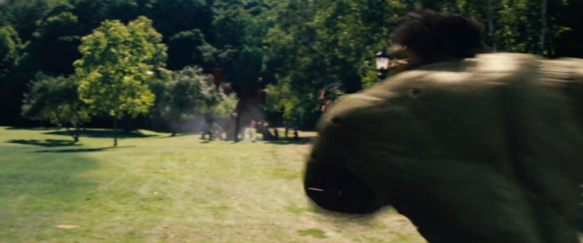 Hulk charging across a lawn towards soldiers.