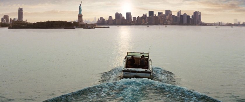 A motorboat sails towards New York City.