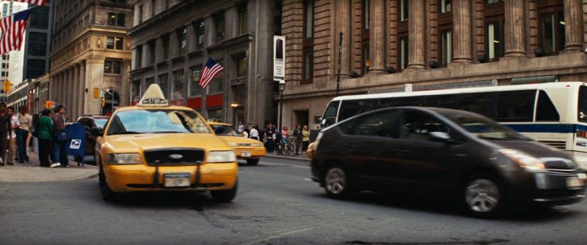 A yellow cab on a busy New York street.