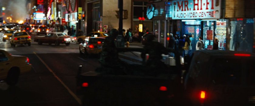 A crowded night time street in Harlem.