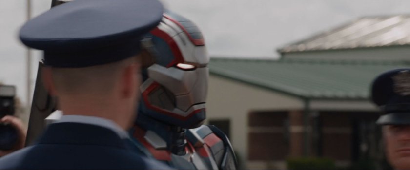 Iron Patriot approaches a red carpet on a tarmac.