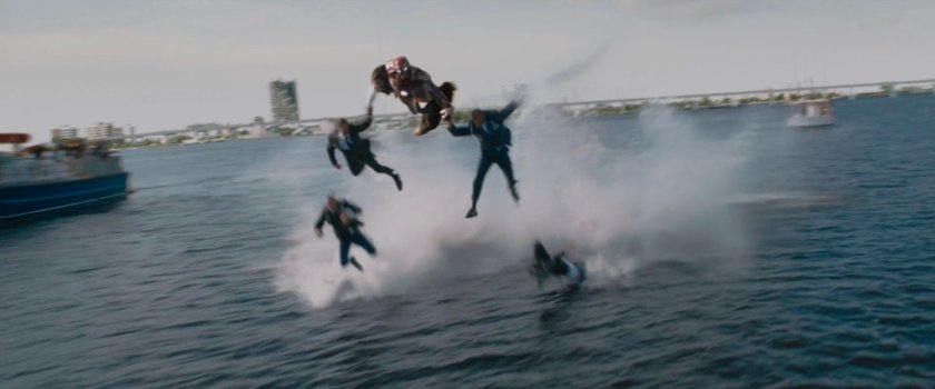 Iron Man rescuing people and dropping them into river.