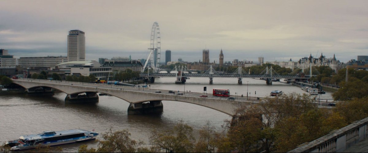 Waterloo Bridge over the Thames in London with London Eye and Big Ben in background.