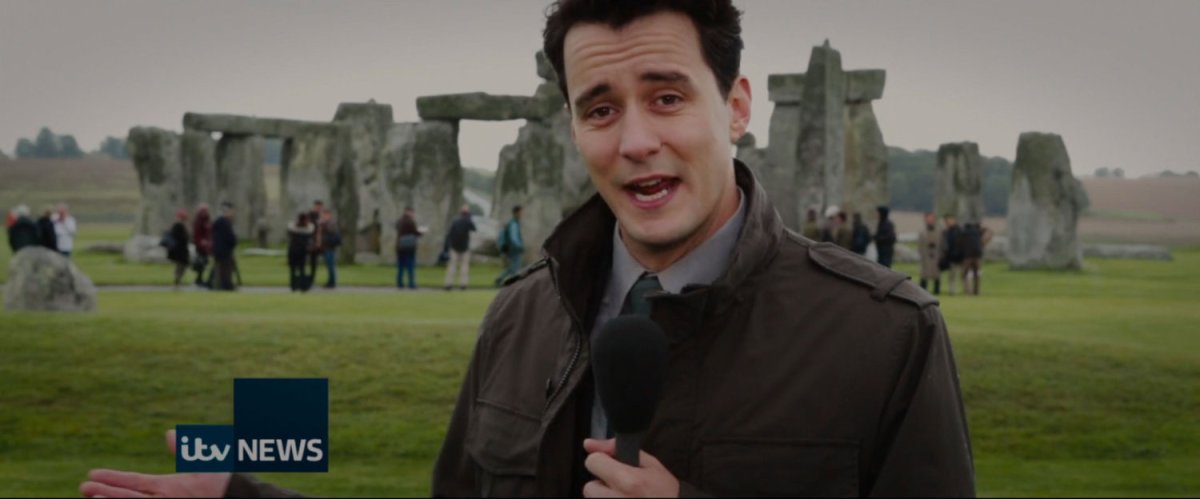 News reporter in front of Stonehenge.