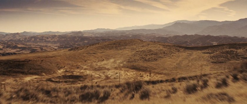 A crater within desert hills.