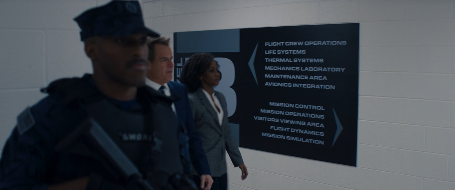 Monica Rambeau, Director Hayward and a soldier in a white hallway within SWORD.