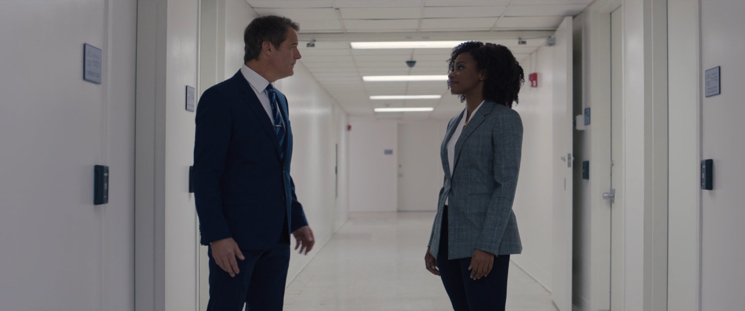 Monica Rambeau and Director Hayward in a white hallway within SWORD.