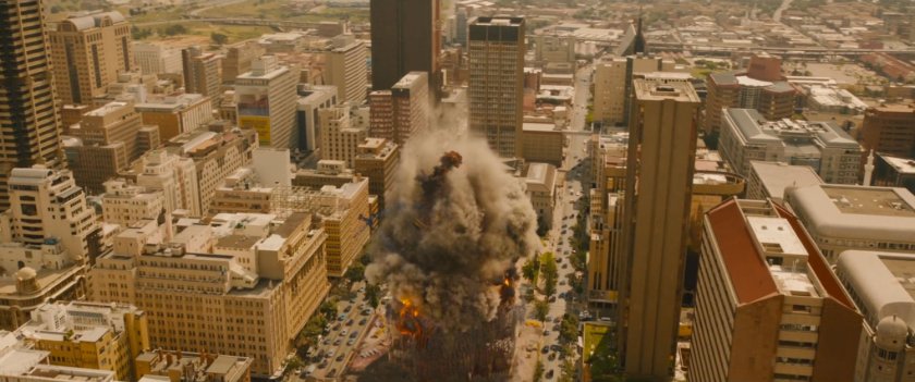 Aerial view of skyscraper imploding.