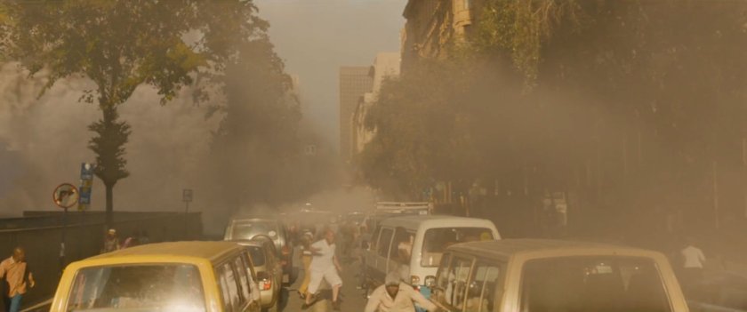 Stopped cars on a smokey street.