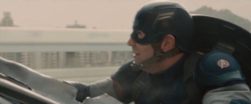 Close-up of Captain America hanging onto truck.