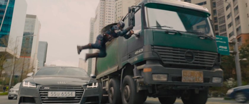 Captain America swings on trucks side mirror.