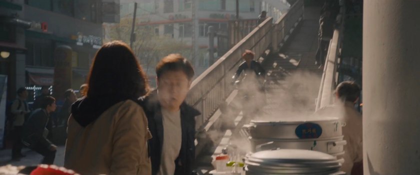 The Black Widow on a motorcycle speeds down a staircase.