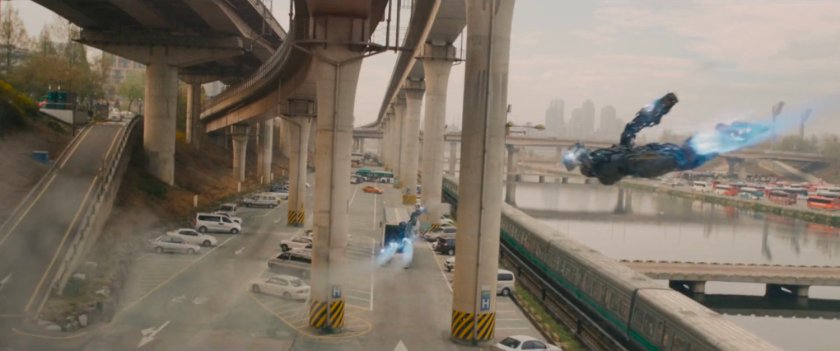 Nigh angle of truck driving through parking lot under expressway.