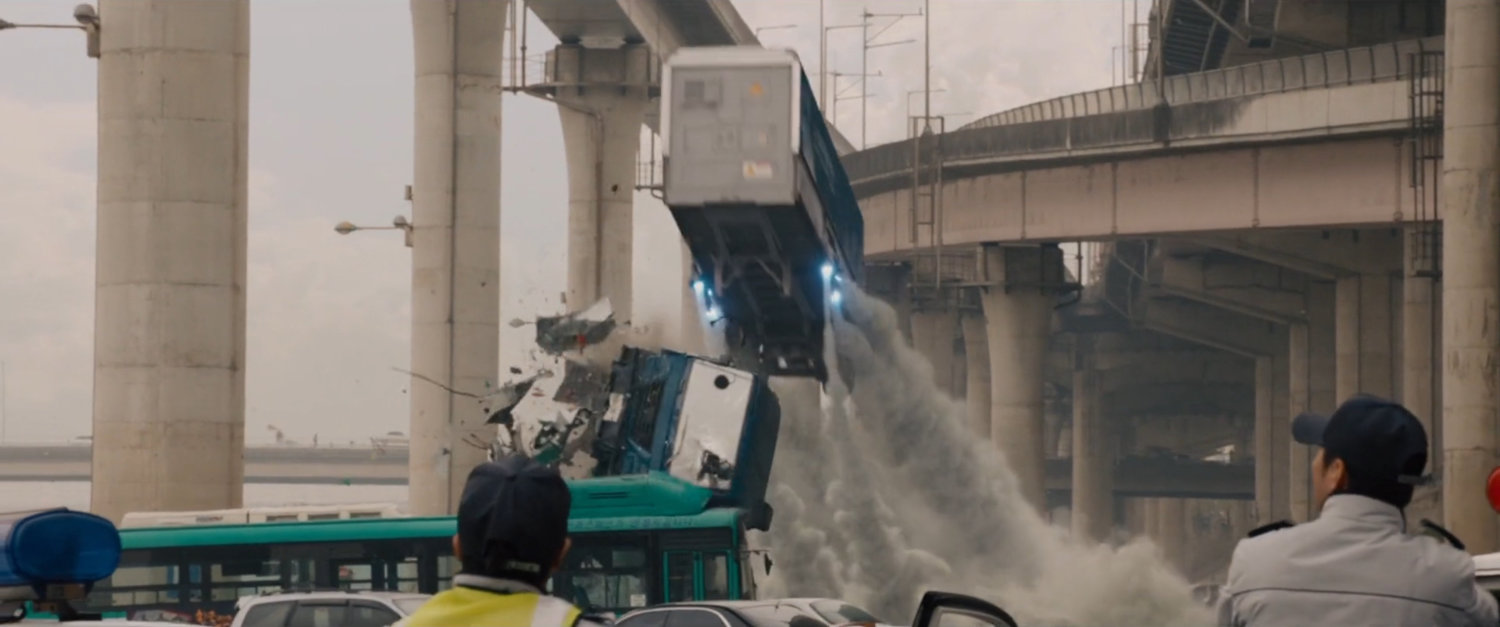 Ultron drones take flight with truck in parking lot under expressway.