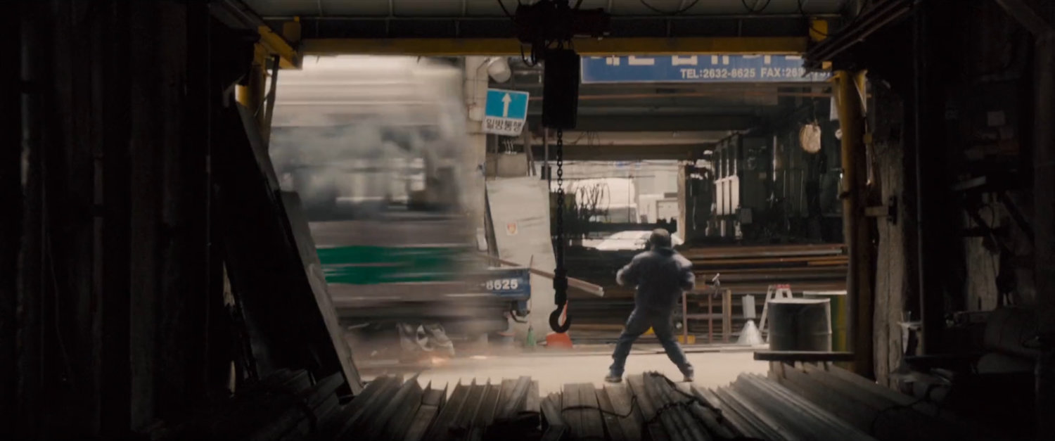 Speeding train jumps off tracks and races through pedestrian street past onlooker.